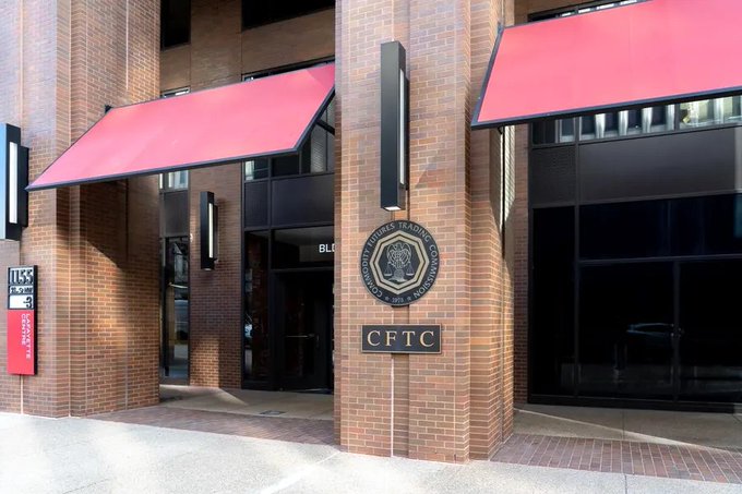 Photograph of the CFTC (Commodity Futures Trading Commission) building exterior with red awnings and the agency's seal displayed on the brick facade.