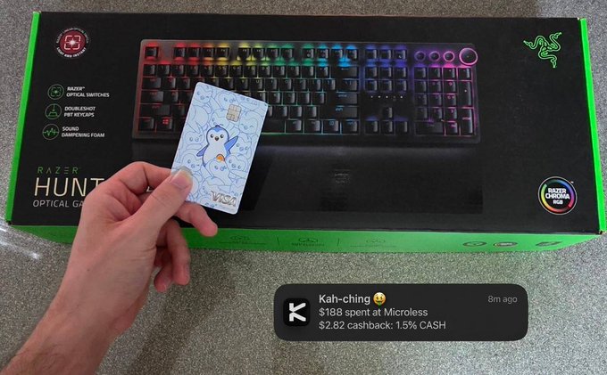 A hand holds a small card in front of a Razer Huntsman Optical Gaming Keyboard box, with a notification overlay showing 'Kah-ching: $188 spent at Microless, $2.82 cashback: 1.5% CASH'.