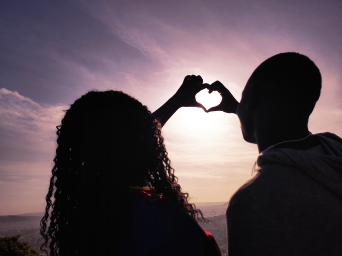 The image features a man and woman silhouetted against a beautiful sky with a sunset or sunrise, making a heart shape by holding hands together as an expression of love and affection towards each other. The photo conveys a sense of warmth, joy, and unity through this simple yet powerful gesture that bridges the gap between two individuals. This image connects well to the post because it depicts their shared emotions in a visually striking way while also referencing a relevant topic from finance (CT @useTria and @quip network) by comparing their love for each other with the concept of sharing or collaborating on something together.
