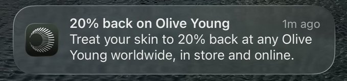 Mobile notification from an app offering '20% back on Olive Young,' promoting a skincare discount available worldwide in-store and online, marked as '1m ago.'