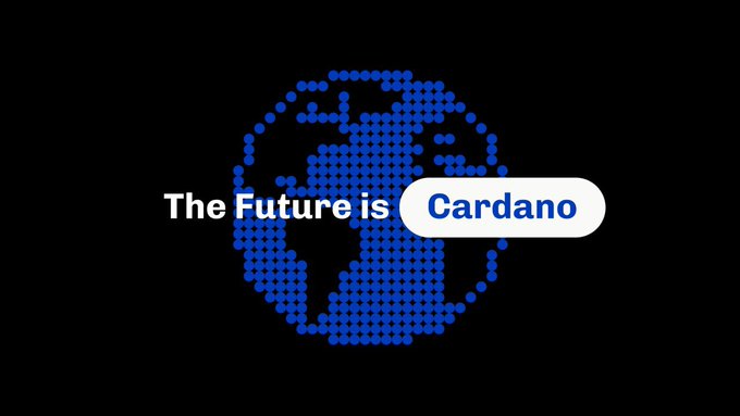 A digital graphic on a black background features a blue dotted globe with the text "The Future is" followed by "Cardano" displayed inside a white pill-shaped badge.