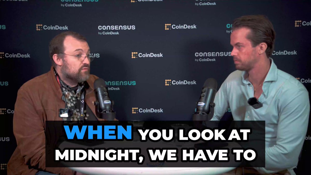 The image shows two men sitting at a table, with microphones placed between them as they appear to be having a conversation or participating in an interview. The background features a black wall with white text that reads "When you look at Midnight, we have to". This suggests that the image is related to a podcast or online event where the hosts are discussing the concept of privacy and security in the context of AI agents.