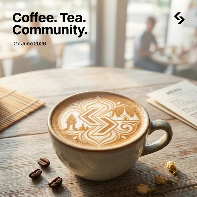 A beautifully crafted latte with intricate foam art sits on a wooden table, accompanied by scattered coffee beans and a menu, with the text "Coffee. Tea. Community. 27 June 2026" overlaid. The image captures the warm, inviting atmosphere of a café gathering, perfectly matching the post's announcement of a community meetup the day before the event.