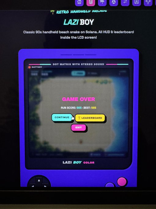 A screenshot showing an arcade-style game called 'LAZI BOY' on Solana blockchain, described as 'Classic 90s handheld beach snake on Solana' with a retro LCD screen display showing 'GAME OVER' with a run score of 565 and best score of 565.