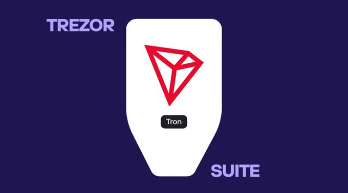 The image features a stylized white hardware wallet on a dark navy background, displaying the red TRON diamond logo and a "Tron" button, alongside the text "TREZOR" in the top left and "SUITE" in the bottom right. It visually represents the announcement that TRON is now natively supported within Trezor Suite, symbolizing secure management of TRX, USDT, and TRC20 tokens through the trusted Trezor hardware wallet.