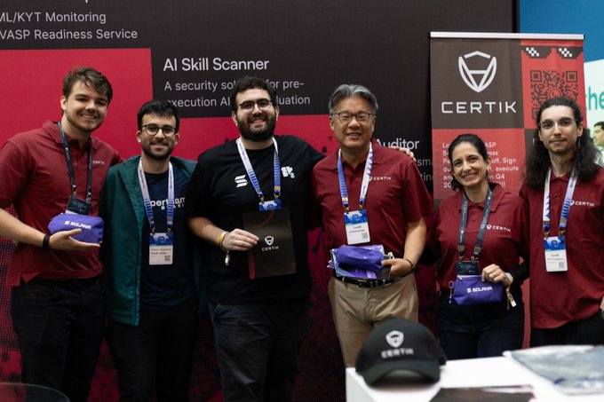 Six people wearing maroon Certik-branded shirts and lanyards pose at a booth, with signage for 'AI Skill Scanner' and 'CERTIK' visible behind them.