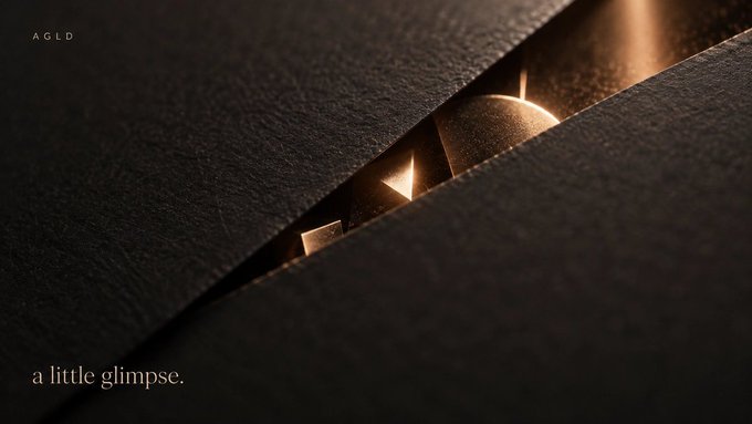 A dark, atmospheric image with the text 'AGLD' in the top left and 'a little glimpse.' at the bottom left, featuring a narrow opening between dark surfaces revealing a glowing golden shape.