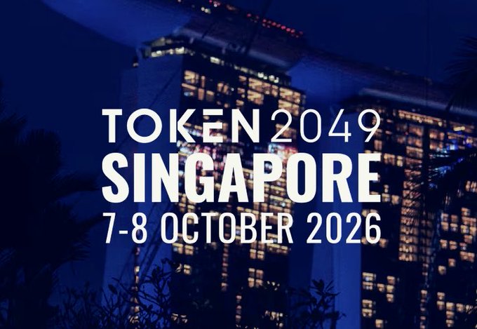 A promotional graphic for TOKEN2049 Singapore, taking place October 7-8, 2026, set against a nighttime backdrop of the illuminated Marina Bay Sands hotel. The image directly complements the post's excitement about attending the conference at that iconic venue alongside fellow builders and founders.