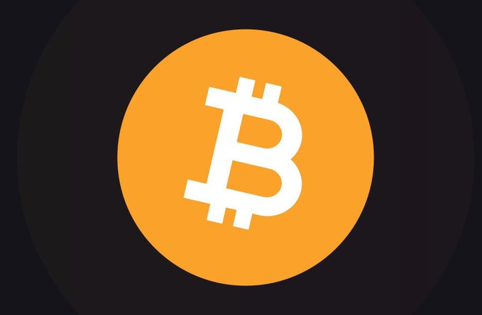 The image features a large, circular logo with an "B" inside of it. The background of the image is black, which contrasts with the bright orange logo. There are no other objects or texts present in the image. The caption at the bottom of the image reads: "Do you think Bitcoin will cross $150,000 in 2026?". This question seems to be related to the content of the image and could potentially be a discussion about the future value of Bitcoin or its potential impact on the market.