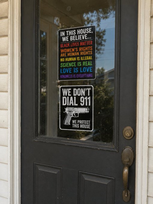 The image shows a black door with two stickers attached to it - one reading "In this house, we believe" and another stating "We don't talk about guns." The door has a brass handle that adds an elegant touch to its appearance. The stickers convey messages related to women's rights, gun control, and the importance of community. The image also includes text that reads "#SOLANA. Nothing".
