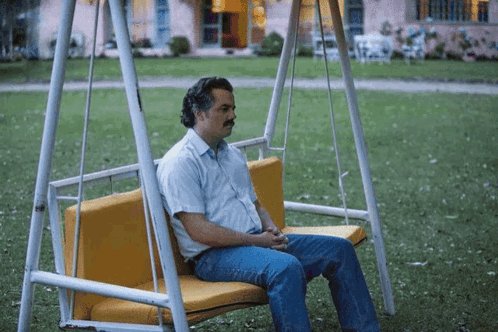 The image shows a man sitting on a swing, which appears to be yellow with an orange seat cushion. The man has his head down and seems to be looking at something off-camera. In the background, there are some potted plants visible, suggesting that they might be in someone's backyard or garden area. The post also mentions that the clock is showing 5 minutes until a protocol breach, which could imply that the man on the swing has been waiting for this moment to arrive.

The image seems to be related to a TV show or movie called "Pov: FCFS holders staring at the clock right now, 5 minutes until protocol breach." The post suggests that the man sitting on the swing is waiting for the scheduled time of the protocol breach in the story.