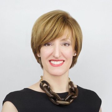 Caitlin Long, CEO of Custodia Bank, smiles for a professional portrait against a plain white background, wearing a black top and a chunky gold chain necklace. The image accompanies a quote from her predicting that all stocks will be tokenized and traded on major exchanges like NYSE and NASDAQ within 12 to 24 months.