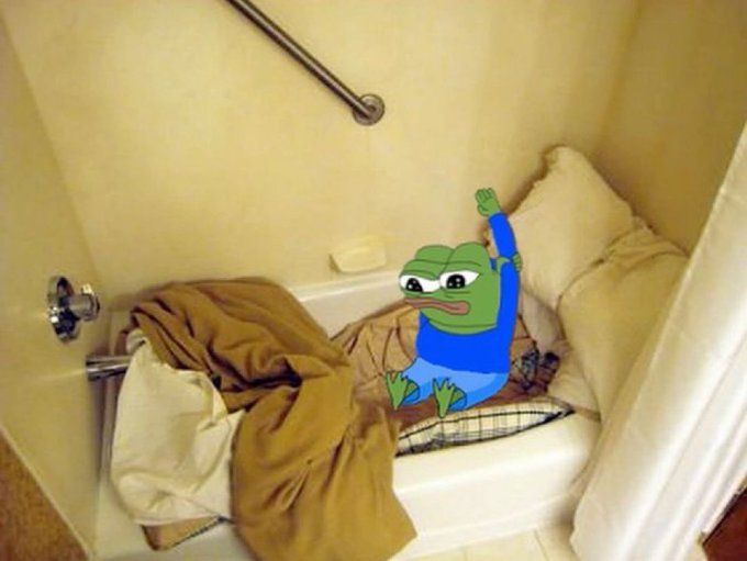 A Pepe the Frog meme sticker edited into a photo of someone huddled under blankets on a bathtub, with the frog's arm raised.