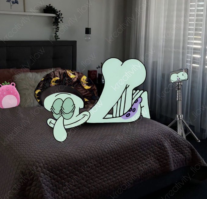 A bedroom scene with a Squidward Tentacles cardboard cutout positioned on a bed, with a tripod and phone visible in the background, overlaid with 'Kreactivity_flow' watermarks.