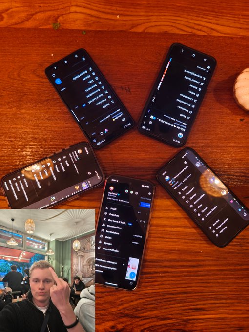 The image features a wooden table with five cell phones arranged around it, each displaying different apps or settings. The phones are positioned at various angles, creating an interesting visual effect. In addition to the phones, there's also a photo of a person in front of them, possibly indicating that they were taken during a gathering or event where people posed for pictures while using their cell phones.
