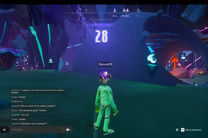 The image shows a character standing in front of a large screen with the number 28 displayed prominently above them. The character appears to be engaged in a conversation or discussion with another player, possibly from GMing.com. The game seems to be set in a virtual world where players can level up and progress through various challenges. The focus on the character's interaction with the other player suggests that they might be discussing their current status, sharing information about the game environment, or planning their next move.