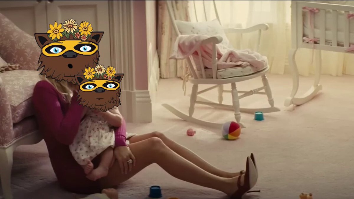 The image features a woman holding her baby while sitting on the floor, with a rocking chair nearby. A cute cartoon cat mask is placed over their heads, adding a playful touch to the scene. The caption for the image reads "Join the Bear family @BearXRPL".