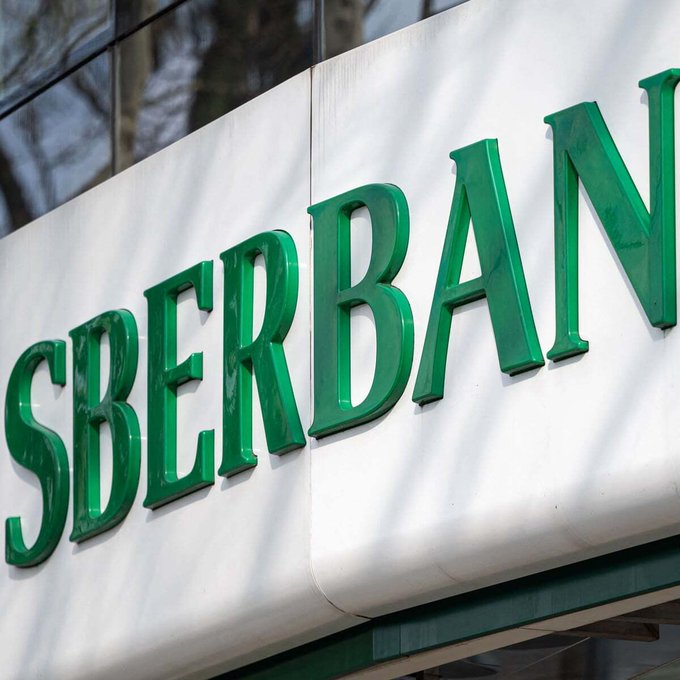 A green and white sign displays the letters "SBERBA" in bold green capital letters, representing the Sberbank logo. The image visually corresponds to the news that Sberbank is introducing crypto-backed lending services for Bitcoin, Ethereum, and USDT.