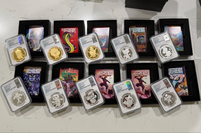 A collection of ten graded coins displayed in plastic slabs alongside various "Jeefriends" themed cards or boxes.