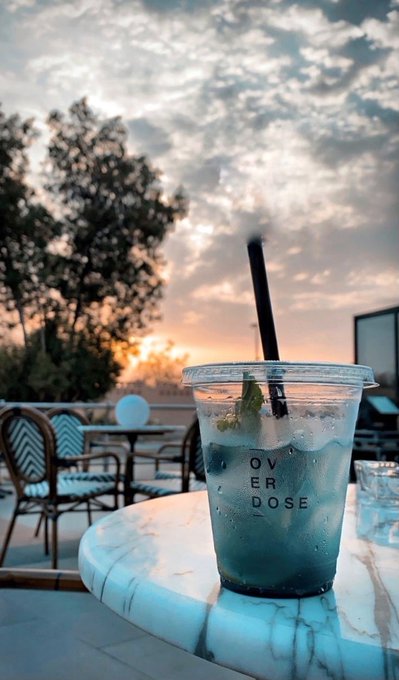 The image features a table with a drink sitting on top of it, which appears to be a blue-colored beverage. The setting includes chairs around the dining table, suggesting an outdoor or semi-outdoor environment. There are also some trees visible in the background, adding to the ambiance of the scene. The photo is related to a post about quantum computing and its impact on reality, as it highlights how technology is rapidly advancing and changing various aspects of our lives.

The drink's blue color could be due to the presence of food coloring or artificial coloring used in the beverage. This image captures a moment where people are enjoying their time outdoors while engaging with new technological advancements that are shaping the future.