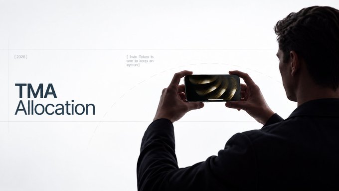 A promotional graphic titled 'TMA Allocation' featuring a person in a dark suit holding a smartphone displaying a golden spiral pattern against a light background.