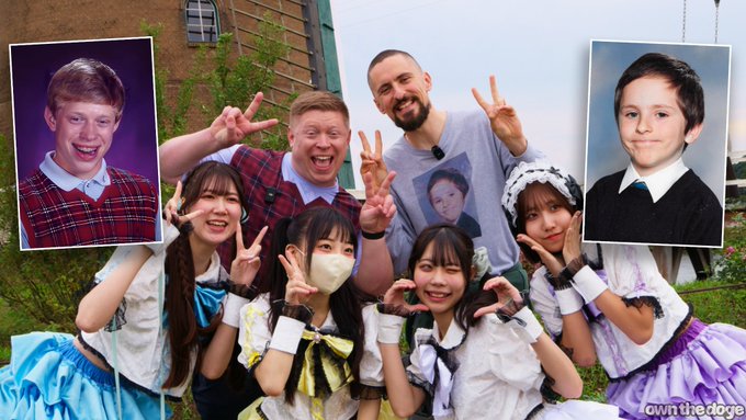 A group of cosplayers in maid-style outfits pose with peace signs alongside a man in a gray t-shirt, flanked by school portrait photos of a red-haired boy and a dark-haired boy; the image is watermarked 'downthelodge'.