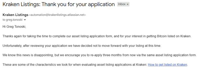 A rejection email from Kraken Listings to "Greg Tonoski" informing him his application to list an asset on Kraken was denied, with advice to re-apply in three months—humorously tied to a meme about failed attempts to get listed as "the real Bitcoin."
