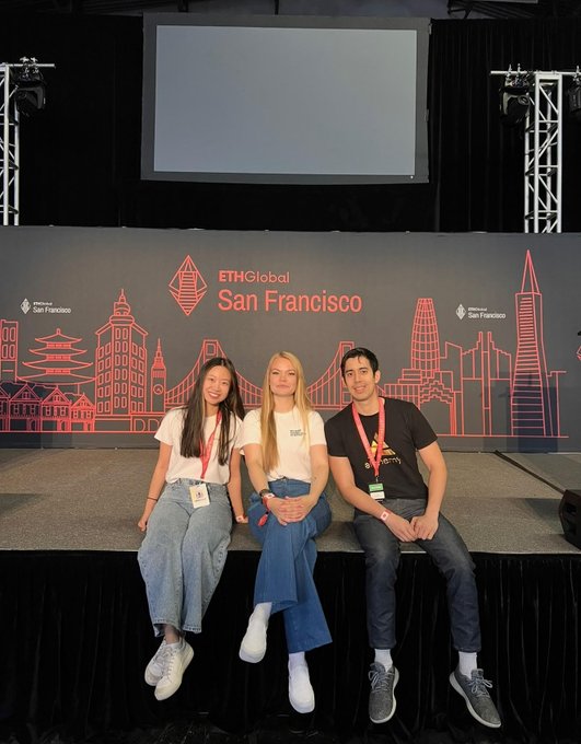 irtc-clouds.com/san francisco hosts a tech conference, featuring three individuals on stage with a large screen displaying the event's logo and name.