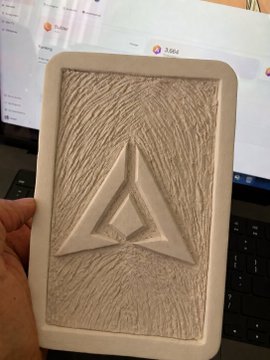 A 3D-printed or sculpted rectangular plaque featuring an Ethereum logo design with textured wood-grain pattern on a light beige material.