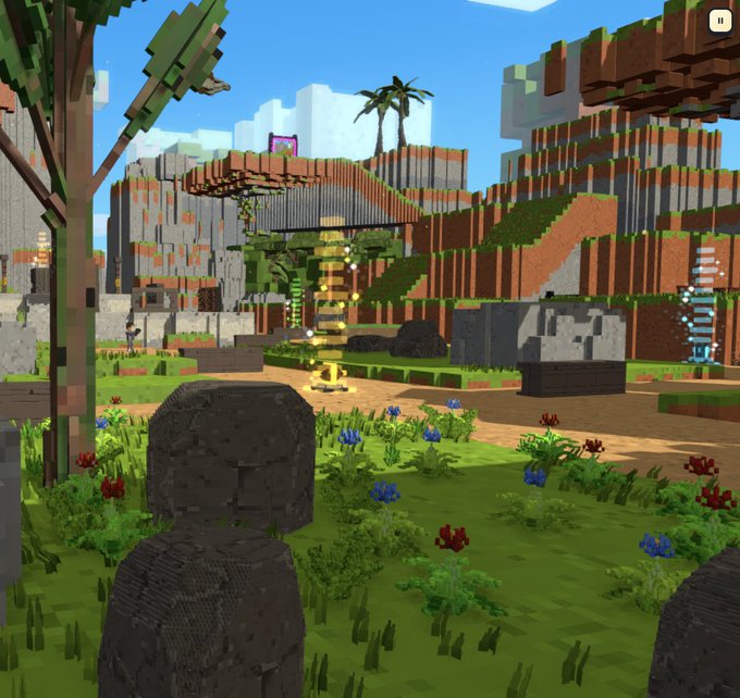 A voxel-style 3D video game scene featuring blocky terrain, trees, a stone statue in the foreground, and a glowing yellow spiral structure in the distance.