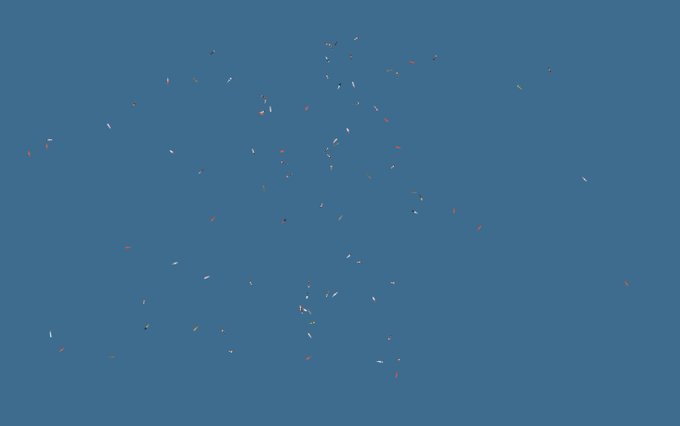 An abstract image showing small scattered colorful marks on a solid blue background.