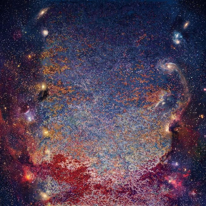 A vibrant, abstract cosmic scene resembling a nebula or galaxy filled with countless blue, orange, and red speckled stars against a dark background.