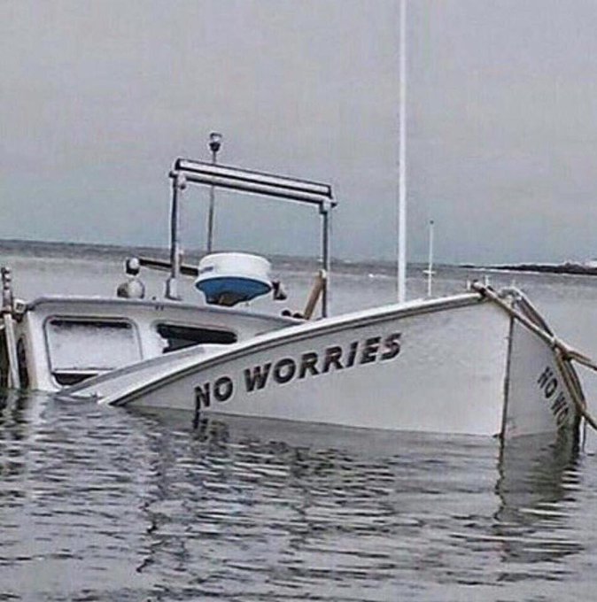 A boat named "NO WORRIES" sits half-submerged in the water, ironically illustrating the post's theme of stepping away from crypto markets to embrace "holiday mode" and accept FOMO rather than stress over missed gains.