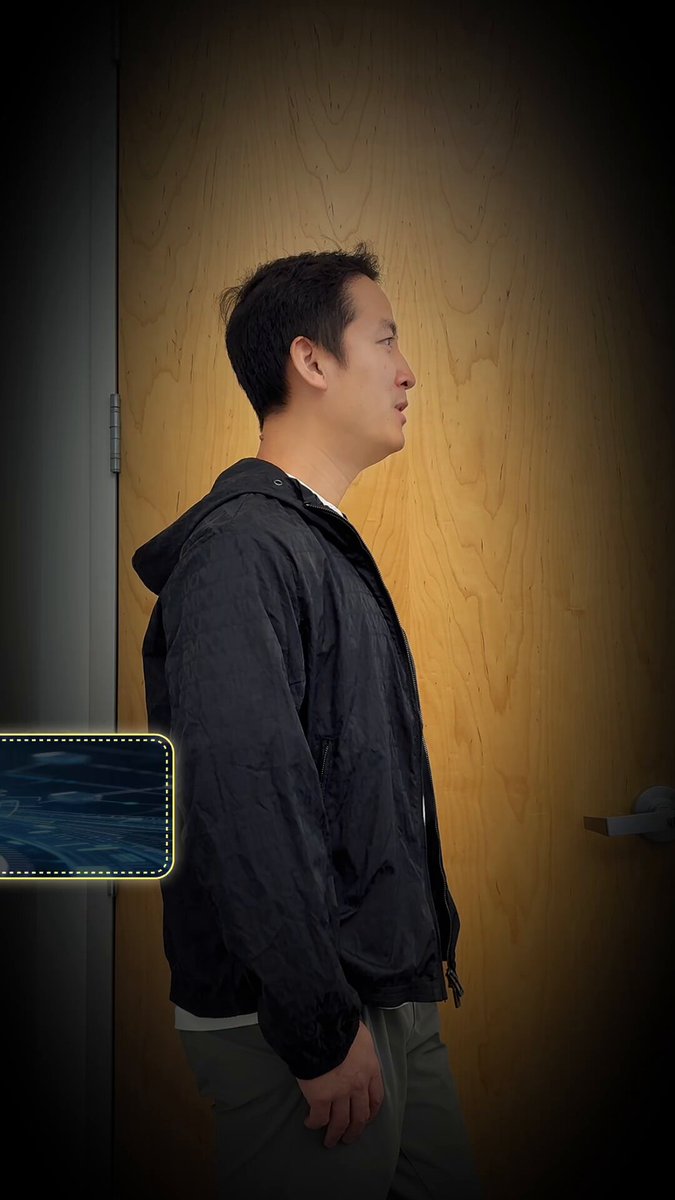 The image features a man standing next to a door with his back turned towards the camera. The background of the photo is dark, which contrasts with the light wood paneling on the wall behind him. There are two blue squares in the bottom left corner of the frame and a black square in the top right corner. The text "OP_CAT" appears to be related to Bitcoin or cryptocurrency, possibly indicating that the man has some knowledge about it.