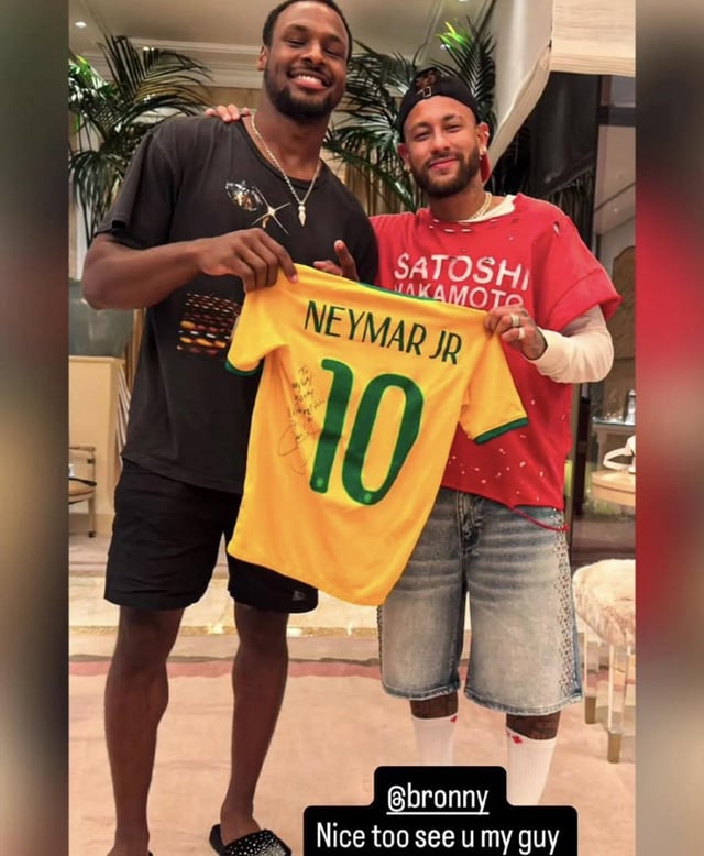 NBA player Bronny James and another man pose together holding a signed yellow Brazil 'NEYMAR JR 10' soccer jersey; an Instagram tag '@bronny' reads 'Nice too see u my guy'.