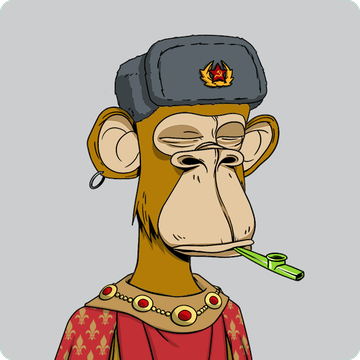 The image features a cartoon monkey wearing a red and gold outfit with a red hat that has a Russian flag symbol on it. The monkey appears to be holding a green pipe or pipe cleaner while sitting down against a gray background, giving off an impression of boredom.