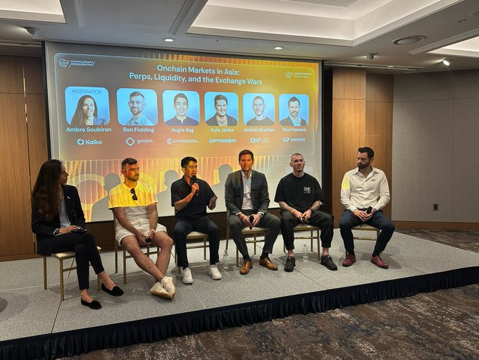 A panel discussion titled "Onchain Markets in Asia: Perps, Liquidity, and the Exchange Wars" with moderator Ambre Soubiran (Kaiko) and panelists from Hashkey Capital, grvt, Chainalysis, Optimism, DWF, and Woox—visually illustrating Kyle Jenke's (Optimism) insights on perpetuals trading and liquidity at the Asia conference.