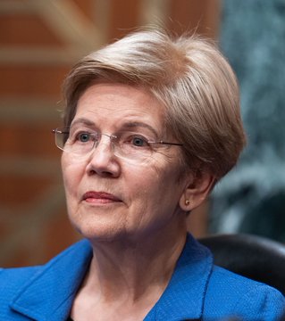 Senator Elizabeth Warren, wearing a blue blazer and glasses, is shown in a close-up portrait, appearing serious as she speaks about her opposition to the Crypto Clarity Act. The image pairs with her statement calling on Congress to prevent the legislation from passing.