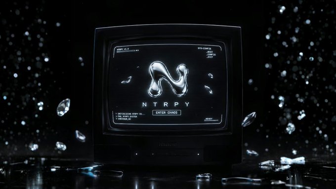 A retro CRT television displaying a silver liquid metal 'N' logo with 'NTRPY' text, surrounded by floating crystal shards in a dark void.