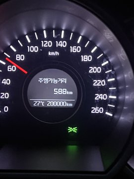 Photo of a car's speedometer displaying 588 km trip distance, 27°C temperature, and 20,000 km odometer reading.