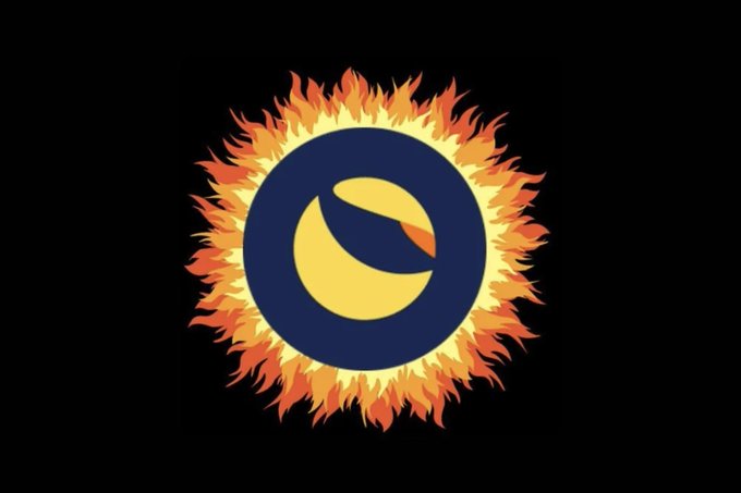 The image depicts a stylized sun with fiery orange and yellow flames radiating outward, surrounding a dark blue circle with a golden symbol inside. This visual represents the "burning" of LUNC (Terra Luna Classic) coins, symbolizing the destruction of tokens to reduce supply, as referenced in the accompanying post about 130 million LUNC coins being burned today.