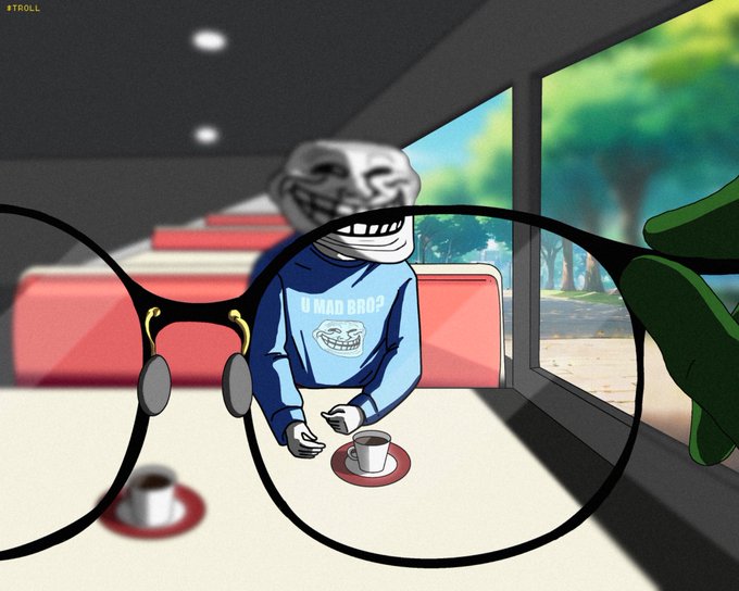 An animated cartoon image viewed through glasses showing a troll face character in a blue 'U MAD BRO?' sweatshirt sitting at a table with coffee cups inside what appears to be a diner.
