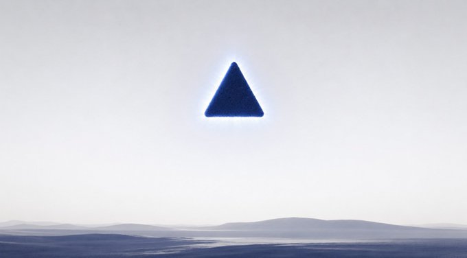 A glowing blue triangle floats above a barren, minimalist landscape.