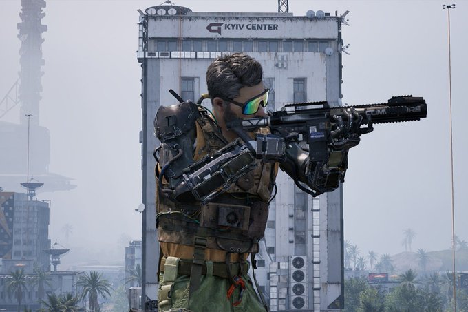 A character from a video game wearing a cybernetic exoskeleton and tactical gear, aiming a rifle in front of a building labeled 'KYIV CENTER'.