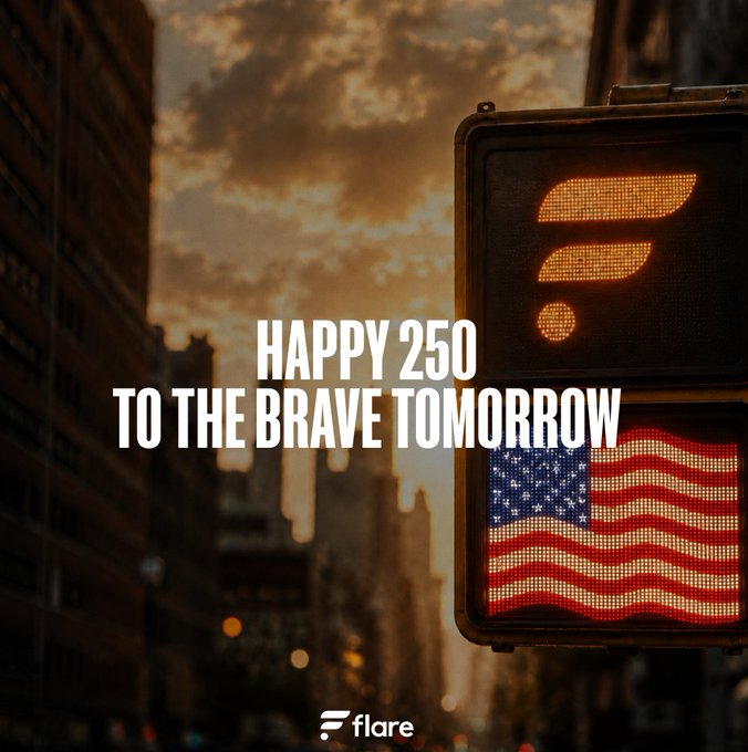 Urban sunset photograph with a pedestrian traffic signal and American flag display, overlaid with the text 'HAPPY 250 TO THE BRAVE TOMORROW' and the Flare logo.