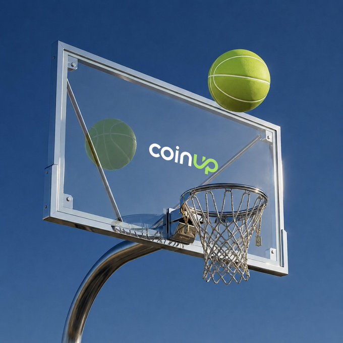 The image features a basketball hoop with two green balls sitting on top of it. The background shows a clear blue sky, which contrasts nicely with the vibrant colors of the balls. The text "CoinUp" can be seen in the image as well.