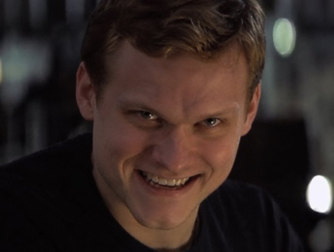 A close-up shot of a man with short brown hair smirking menacingly, his intense expression captioned "Everything is Near's L2," suggesting the image conveys a sense of mysterious alignment or conspiracy with a confident, knowing smirk fitting the phrase.