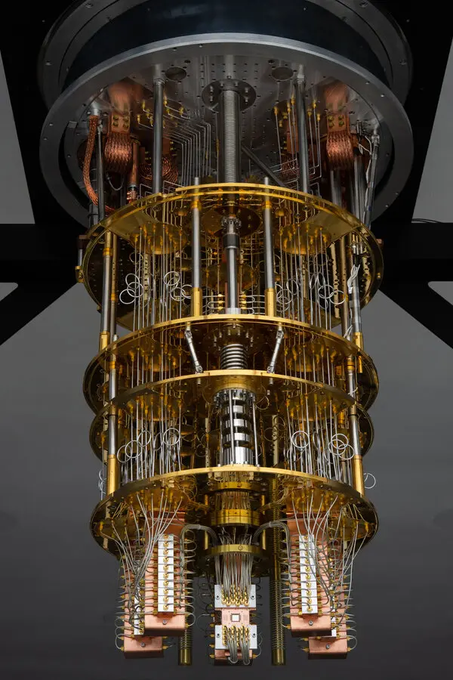 A quantum computer's internal cryostat reveals stacked gold-plated tiers of wiring and processors suspended in a tower-like structure. The intricate hardware visually underscores the threat post-quantum cryptography poses to Bitcoin's security, as half of its supply sits in wallets using legacy encryption that such machines could eventually crack.