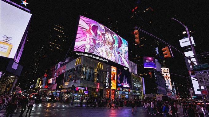 Times Square at night glows with vibrant digital billboards, including prominent McDonald's golden arches ads featuring "RONANSA VAZA BRAMUDYA" and "Popeyes" signage, while crowds of pedestrians gather at the busy intersection under a W 42 St sign. The bustling urban scene captures the energetic NYC atmosphere perfect for greeting "gm @NFT_NYC."