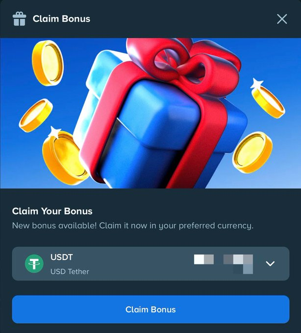 A "Claim Bonus" modal from Stake displaying a blue gift box with red ribbon surrounded by gold coins, offering a bonus in USDT (USD Tether) with a blue "Claim Bonus" button. The image visually reinforces the post's promotion of claiming a Monthly Bonus on Stake, with the gift and coins representing the reward users are encouraged to claim.